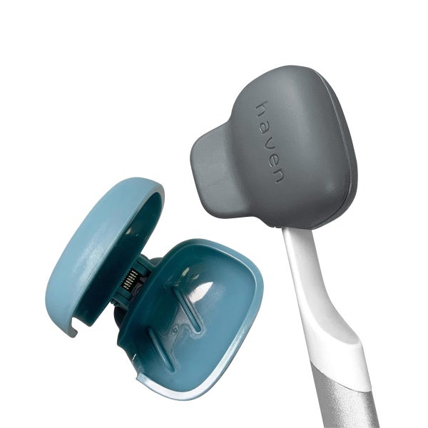 An open blue toothbrush cover next to a silver and white toothbrush with a grey toothbrush cover on it